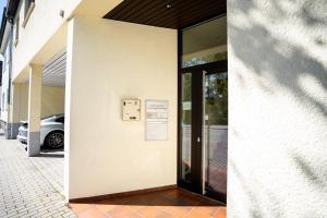 a door to a building with a sign on it at AP Hotel Viernheim Mannheim am Kapellenberg in Viernheim