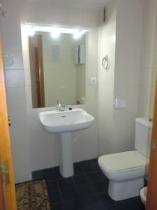 a white bathroom with a sink and a toilet at Piso La Pista Alcora in Alcora