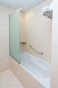 a shower with a glass door in a bathroom at Al Raya Hotel Apartments in Dubai