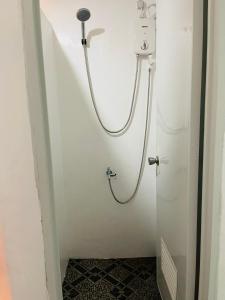a shower in a bathroom with a tile floor at MUBA HOSTEL in Moalboal +13 photos