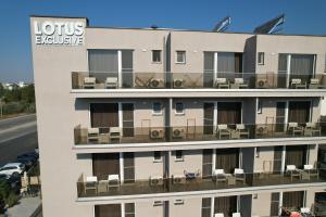 an apartment building with a balcony with chairs at Lotus Exclusive in Mamaia Sat/Năvodari
