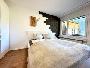 Un dormitorio con una cama grande y una ventana en Cozy place for 2 near Zermatt en Täsch