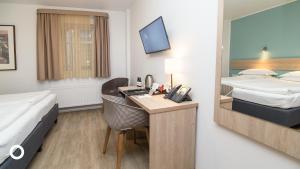 Postel nebo postele na pokoji v ubytování Center Hotels Plaza