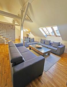 a living room with blue couches and a table at Historic Centre Apartments I in Prague