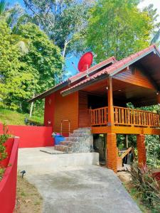 a house with a deck and stairs in front of it at Family Resort in Baan Tai