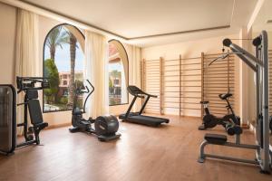 a gym with exercise equipment and a large window at Jaz Tamerina, Almaza Bay in Marsa Matruh