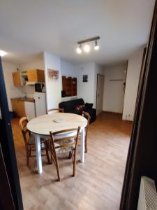 a dining room and living room with a table and chairs at Orelle 3 Vallées - Studio 4 personnes in Orelle