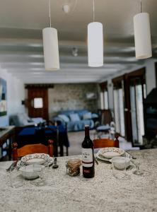 a bottle of wine sitting on top of a table at La Casa de la Acacia in Olba