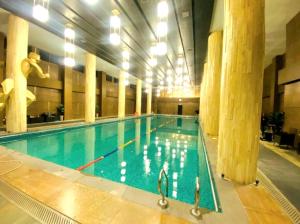 a large swimming pool in a large building at The Chromatic Apartments Bahria Town in Rawalpindi