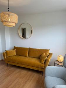 a brown couch in a living room with a mirror at Meeresbrise in Harrislee