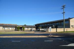 an empty street in front of a building at Adrian Motel in Forbes