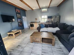 a living room with a couch and a coffee table at Hook Wine And Sinker in Langebaan