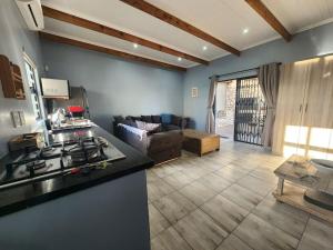 a kitchen and living room with a couch and a stove at Hook Wine And Sinker in Langebaan
