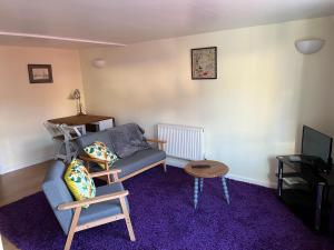 a living room with a couch and a table at The Annex in Ottery Saint Mary