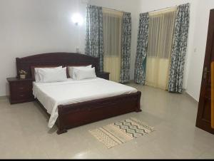 a bedroom with a large bed in a room at Lux Suites Mkomani Beachfront Apartment in Mombasa