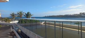 a balcony with a view of the beach and the water at Lux Suites Mkomani Beachfront Apartment in Mombasa