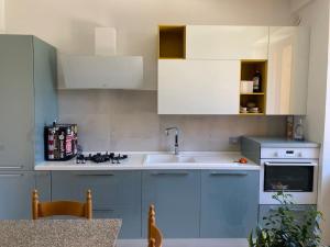 a kitchen with blue and white cabinets and a sink at B&B La vecchia fornace in Teramo