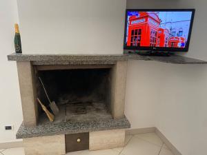 a tv sitting on top of a stone fireplace at B&B La vecchia fornace in Teramo