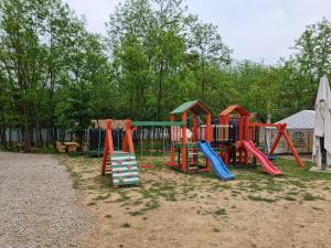 a playground with colorful equipment in a park at Kopićland TENT in Marinci