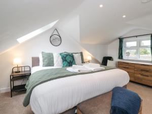 a bedroom with a large white bed and a window at Rydal Rock in Ambleside