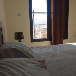 a bedroom with a bed and a window with a view at Dream house hotel jerash in Jerash