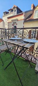 een tafel met twee wijnglazen op een balkon bij Bengale - T2 complétement rénové tout confort in Vichy