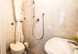 a bathroom with a shower and a toilet and a sink at Giotto Studio Flat in Florence