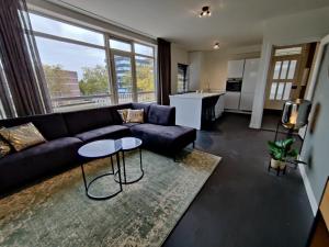 a living room with a couch and a table at Eindhoven City Apartments E 6P in Eindhoven