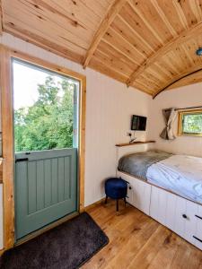 a bedroom with a bed and a large window at Herefordshire Escape, Hot Tub, Firepit, Views, BBQ in Leominster