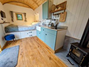 a kitchen with a sink and a stove in a room at Herefordshire Escape, Hot Tub, Firepit, Views, BBQ in Leominster