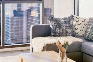 a living room with a couch and a table at Luxurious 2 Bed Apartment with Captivating View in Melbourne