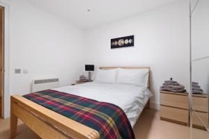 a bedroom with a bed and a sign on the wall at By the Bridge by Toppo in Inverness