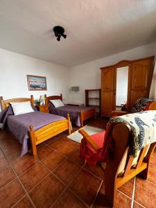 a bedroom with two beds and wooden furniture at CASA COREA IV in Puntagorda