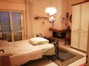 a bedroom with a bed and a fireplace at "vista isole EGADI" Appartamento vicino mare e aeroporto in Rilievo