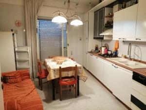 a small kitchen with a table and a sink at "vista isole EGADI" Appartamento vicino mare e aeroporto in Rilievo