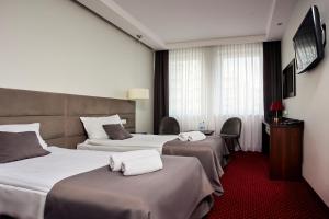 Posteľ alebo postele v izbe v ubytovaní Hotel Maraton