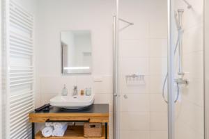 a bathroom with a sink and a shower at Apartments Am Dorfplatzl in Hohentauern