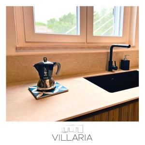 a tea kettle sitting on a counter next to a sink at Villaria Luxury apulian villa with pool in Campomarino