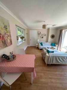 a living room with a bed and a table at Leafy lodge in Lytham in Brown Moss Side