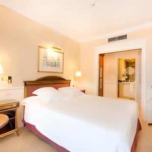 a large white bed in a hotel room at Apartamentos Guadalpin Boutique in Marbella