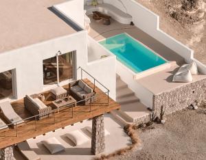 an aerial view of a house with a swimming pool at Infinity Villa milos in Pachaina