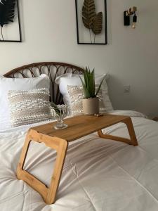 a wooden coffee table on top of a bed at Chambre Les gites de la Gare in Mussidan