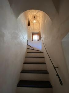 a staircase leading up to a room with a window at Iconic Italian Townhouse w Rooftop Terrace, Pigna in Pigna