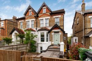 a house with a white door and a fence at Fantastic 2BR flat wgarden, West Norwood in West Dulwich