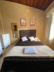 En eller flere senge i et værelse på Pousada Do Pancho