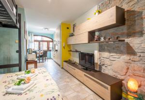 sala de estar con chimenea de piedra y cama en Ca' di Ruchitt- Happy Rentals en Cuasso Al Monte