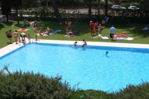 a group of people in a large swimming pool at HESTIA VuT in Ayllón