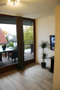 a living room with a sliding glass door to a patio at Messe- und Gästezimmer Hildesheim in Harsum