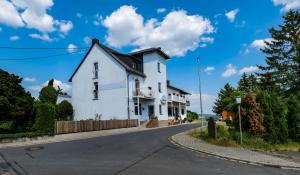 a white house on the side of a road at Haus Koinonia in Langscheid