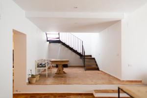 a room with a staircase and a wooden table at Casa Pina in Galaroza